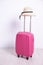 Pink luggage case with wall