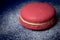 Pink Macaron or Macaroon in blue dish on wooden table.