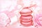 Pink macarons on pastel valentine decor and rose flowers soft background