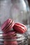 Pink macaroons, french biscuit dessert, sweets at black background