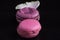 Pink macaroons, french biscuit dessert, sweets at black background