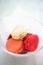 Pink macaroons in glass bowl