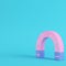 Pink magnet on bright blue background in pastel colors