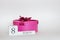 Pink march 8 gift box with a bow on a white background with flower