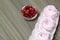 Pink marshmallow in a gift box. Nearby is a bouquet of some cranberries