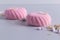 Pink marshmallow Zefir on grey paper background with almonds