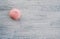 Pink marshmallows on a light wooden background