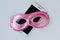 Pink mask on mobile phone - Concept of privacy, security and anonymity of mobile phone for women