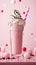 a pink milkshake with whipped cream and chocolate chips