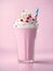 a pink milkshake with whipped cream and strawberries