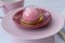 Pink mochi dessert with cream filling and berry.