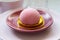 Pink mochi dessert with cream filling and berry.