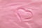 Pink moisturizing cosmetic cream with a painted heart. Beautiful cream texture. Concept. Valentine`s Day