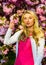 Pink mood. Spring fashion collection. Woman spring flower sakura bloom background. Blonde woman in garden. Gorgeous girl