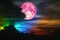 pink moon on colorful cloud and rainbow night sky