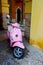 Pink Moped Scooter, in front of colourful walls, Verona Italy