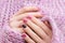 Pink nail design. Female hand with glitter manicure