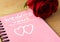 Pink notepad with wedding vows and rose.