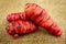 Pink oca new zealand yams closup macro on hessian background