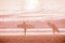 Pink Ocean Landscape in Sunset Time Background with Sandy Beach and Wavy Sea. Surfers stand on the beach with surfboard