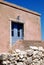 Pink old house with blue shutters and door on the island Susak