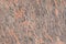 Pink orange black Indian flat granite texture background