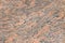 Pink orange black Indian flat granite texture background