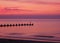 Pink and orange sunrise over North Sea from Lowestoft beach Suffolk