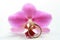Pink orchid and solitaire engagement ring