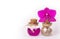 Pink orchid and two glass bottles on a white background. Spa concept. Cosmetic bottles. Ecological natural cosmetics. Copy space.