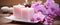 pink orchids, white soap, candles on a table