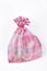 Pink organza bag with jewelry.