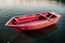 Pink origami boat floats on tranquil water