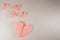 Pink origami hearts on a paper background