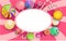 Pink oval background with colorful lollipops.
