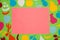 pink paper as copy space around it green part of the background with colorful paper fruits, creative diet design