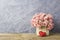 Pink paper carnation in weave basket on old wood