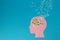 pink paper head on a blue background, instead of a daisy brain whose petals flew all around