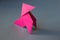 Pink paper hen origami isolated on a grey background