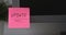 Pink paper notes with the reminder Update on it sticked on to a monitor at an office workplace.