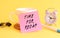 Pink paper with the text TIME FOR RECAP on a white cup. Clock, pen on a yellow background