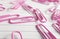 Pink paperclips scattered on white lined paper