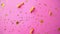 Pink party background with golden confetti and serpentines