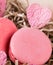Pink pasta Macaron and heart, against a background of paper chips