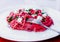 Pink pasta on a white plate with a fork