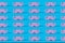 Pink pastel mustache pattern and on a blue background. A symbol of father day.