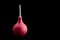 Pink pear white tip for enema, isolate on a black background