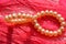Pink pearls bracelet pink background