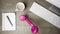 Pink phone receiver falling onto office desk