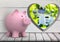 pink piggy bank in front of wood wall with heart hole where we can see a house (blurred)